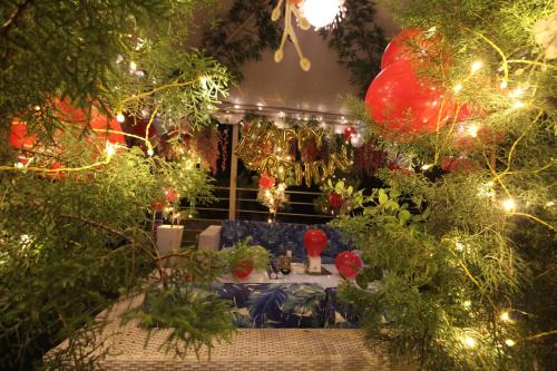 a room with a table with christmas lights at Moksha Riverside Resort in Kasol