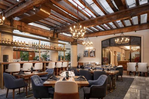a restaurant with tables and chairs and a bar at JW Marriott Quito in Quito