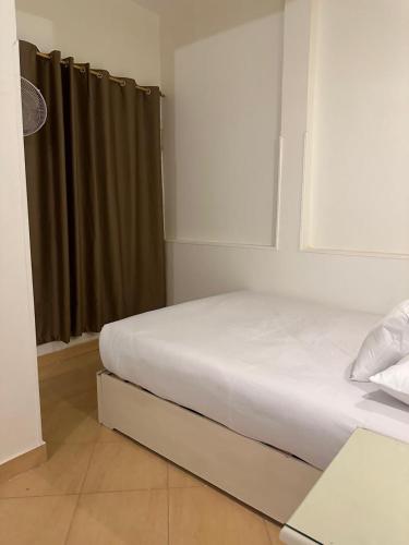 a white bed in a room with a window at Eka- Guesthouse in Aswan