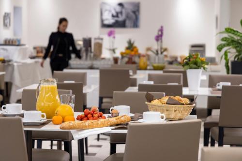 a table with food and fruit on it in a restaurant at Hôtel De Castiglione in Paris