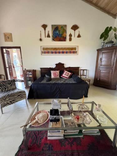 a living room with a bed and a glass table at Emel's Retreat By Tropical Magnum - Luxury Boutique Villa in Anhandigoda