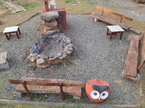 a toy park with benches and a stone fireplace at Pousada e Camping Tio Wil in Extrema
