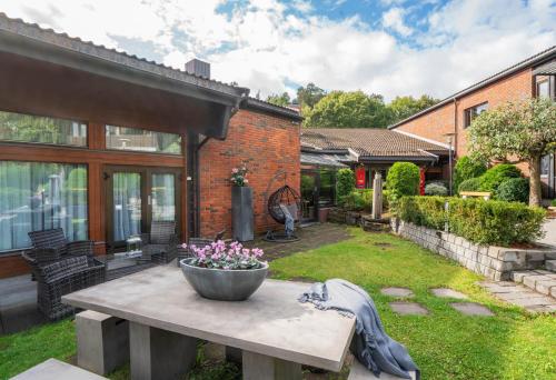 a backyard with a concrete table with flowers on it at Thon Hotel Vettre in Asker