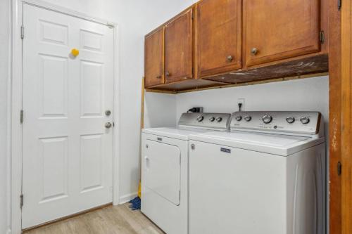 a kitchen with a white stove and a washer at Herbalist Farm in Jacksonville