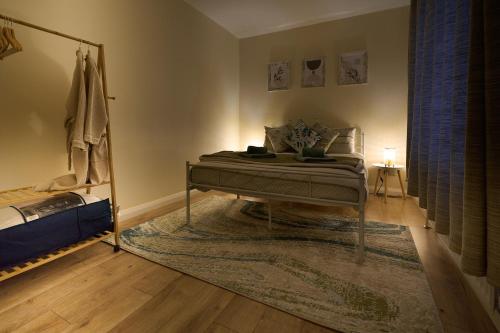 a bedroom with a bed and a mirror in a room at Dundrine Cottage in Maghera