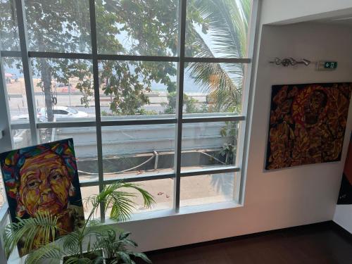a room with a large window with a plant in front of it at Art House in Luanda