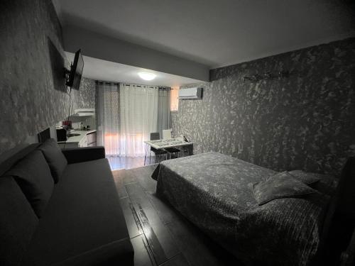 a bedroom with a bed and a couch in it at Estudio Loft in La Pineda
