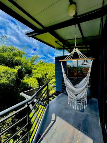 a hammock hanging from a roof on a balcony at Entre Bambús in Pereira