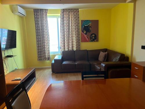 a living room with a couch and a table at Art House in Luanda