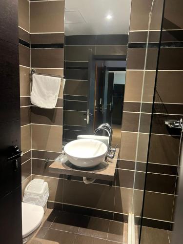 a bathroom with a sink and a toilet at Art House in Luanda