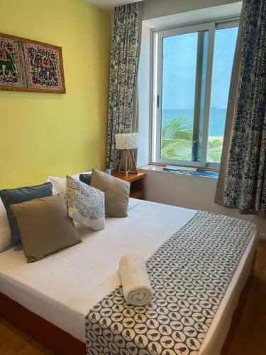 a bedroom with a bed with a view of the ocean at Art House in Luanda