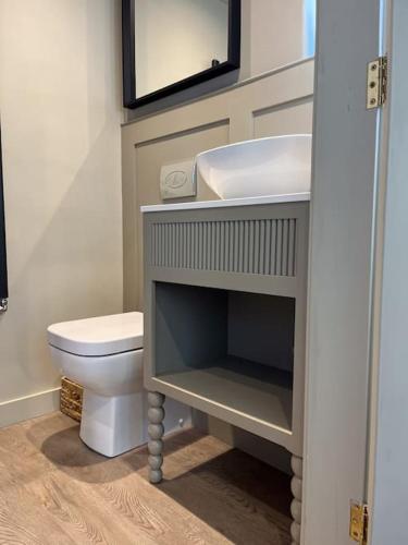 a bathroom with a sink and a toilet at Victorian Red Brick Barn in the Heart of Stamford in Lincolnshire