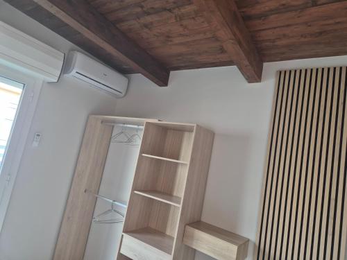 a kitchen with a refrigerator and a wooden ceiling at Attico Solaris in Reggio Calabria