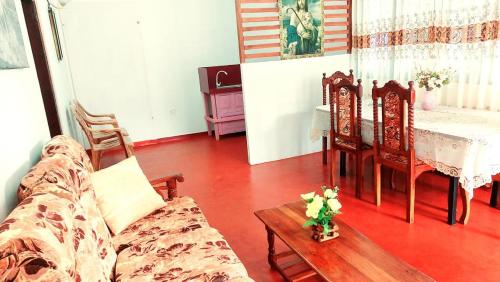 a living room with a couch and a table at Sohansa Guesthouse in Weligama