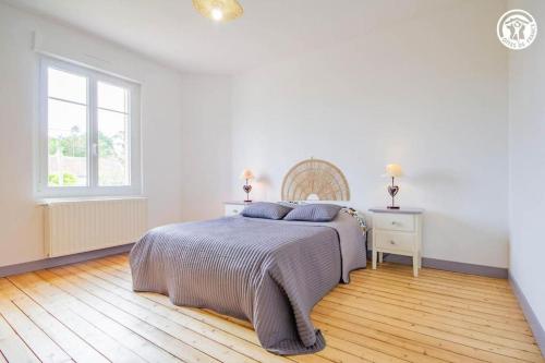 a white bedroom with a bed and a window at L'Albatros, Villa de charme familiale classée 3 étoiles, All inclusive in Paray-le-Monial