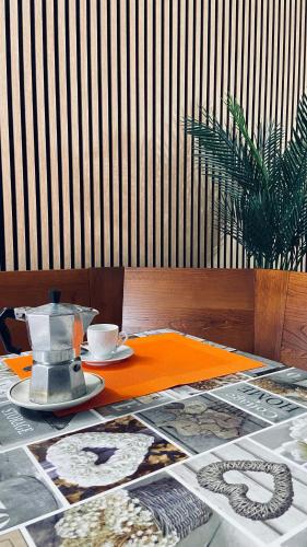 a table with a tea pot and a plate of food at Appartamento/ mansarda nel cuore del Pollino in Viggianello