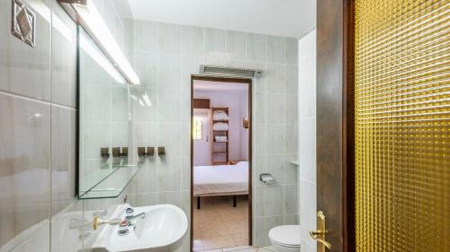 a bathroom with a sink and a toilet and a mirror at Chalet El Nido Níjar by Ruralidays in Níjar