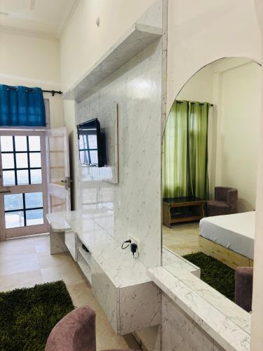 a bedroom with a large marble counter and a bed at Himalayan Canvas khajjiar in Khajjiar 