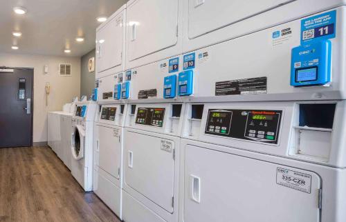 a laundry room with washers and dryers in a store at Extended Stay America Select Suites - Orlando - South in Orlando
