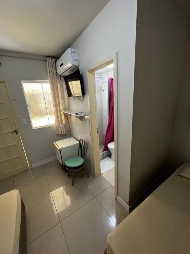 a small room with a room with a bathroom at Pousada Morada das Nações in Balneário Camboriú