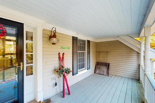 a porch with skis on the side of a house at Moose Lodge in Newry