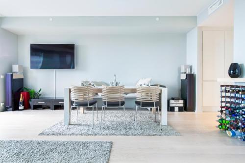 a dining room with a table and three chairs at Super Central Designer Penthouse at 19th floor with Amazing View! in Oslo