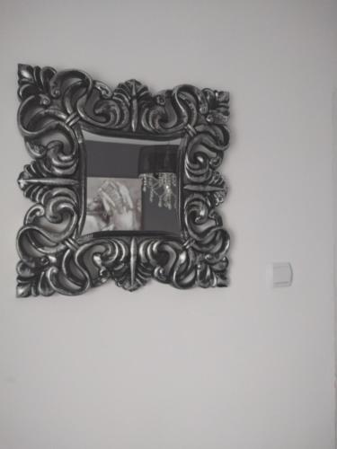 a black mirror hanging on a wall at Vikendica Gaj in Gornji Milanovac