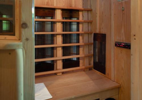 a room with wooden shelves and a room with books at Hotel Land Gut Höhne in Mettmann