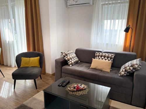 a living room with a couch and a table at Green Lux Apartment in Inđija