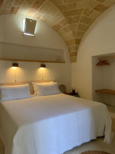 Ένα ή περισσότερα κρεβάτια σε δωμάτιο στο Relais Masseria Sant'Antonio