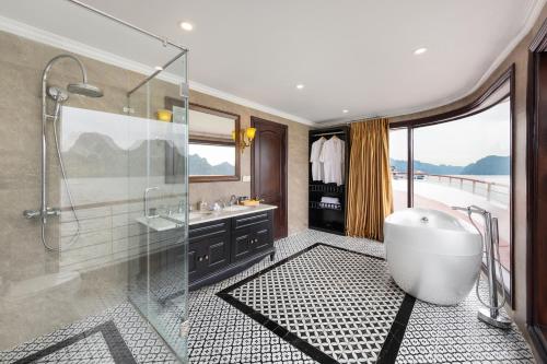 a bathroom with a tub and a glass shower at Aqua Of The Seas Cruise Halong in Ha Long