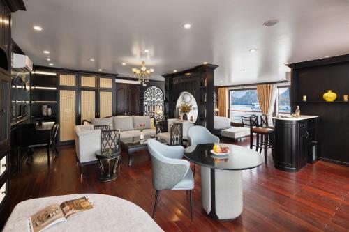 a living room with chairs and a table at Aqua Of The Seas Cruise Halong in Ha Long