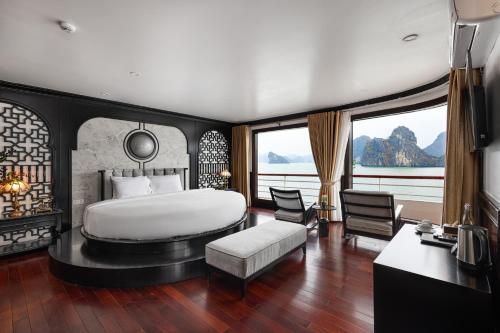 a bedroom with a large bed and a large window at Aqua Of The Seas Cruise Halong in Ha Long