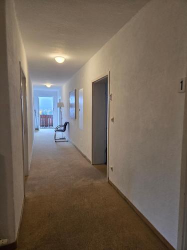 an empty hallway with a hallway leading to a room at Wald Cafe in Simbach am Inn