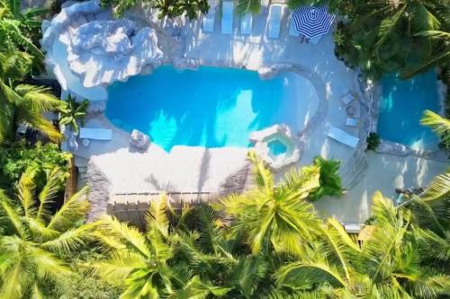 an aerial view of a resort pool with palm trees at Bungalows Beach Key West - Azucar in Key West