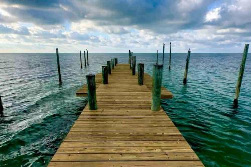 a wooden pier in the middle of the water at Bungalows Beach Key West - Azucar in Key West