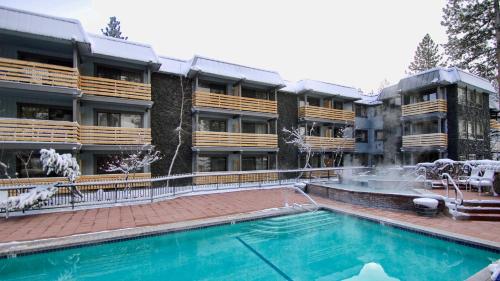 a swimming pool with a fountain in front of a building at Hotel Azure in South Lake Tahoe
