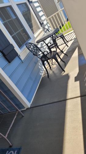 a pair of chairs sitting on the porch of a house at Cozy SFH for Active Adults in Middletown
