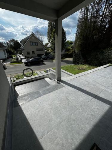 a porch with a view of a house at Villa Brussel in Dilbeek