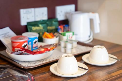 a table with two plates and bowls of food at Marlborough House - Guest House in Oxford