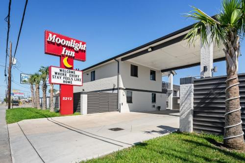a building with a sign for a moroccan inn at Moonlight Inn - Houston I-45 & Airline in Houston