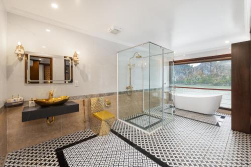 a bathroom with a glass shower and a tub and a sink at Aqua Of The Seas Cruise Halong in Ha Long