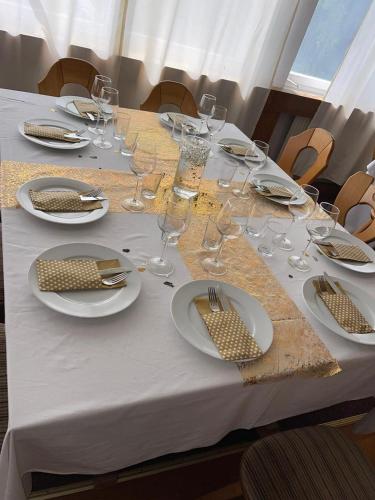 a table with plates and wine glasses on it at Wald Cafe in Simbach am Inn
