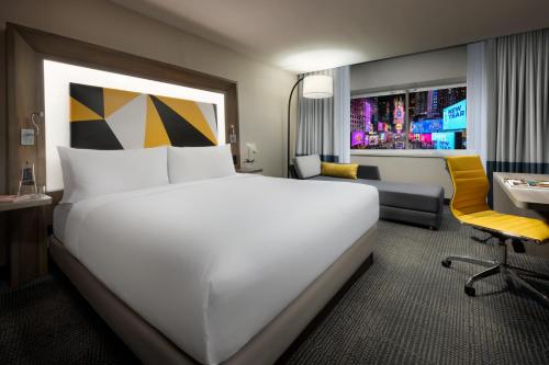 a large white bed in a hotel room at M Social Hotel Times Square New York in New York