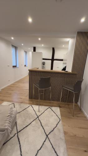 a living room with two chairs and a counter at Deister Apartments in Springe