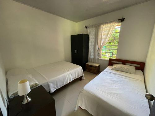Postel nebo postele na pokoji v ubytování Casa Cabaña el paso de los micos