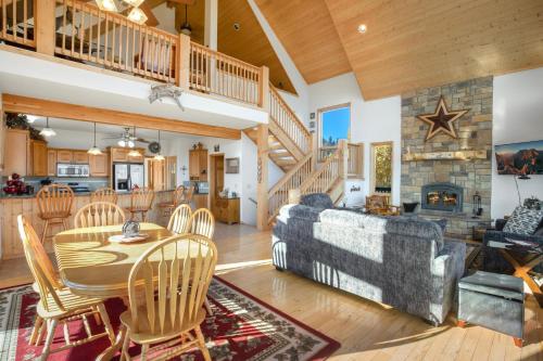 a living room with a couch and a table and a fireplace at Above the Clouds in Creede