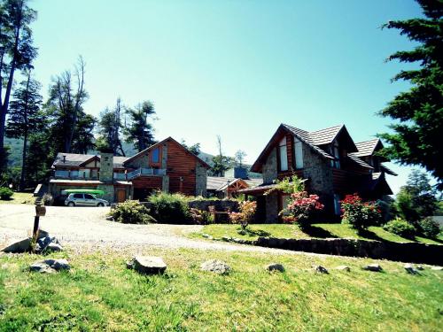 a house with a car parked in front of it at Hosteria Patagon in Villa La Angostura
