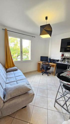a living room with a couch and a table at Le Renoux #Thermes#Confort in Royat