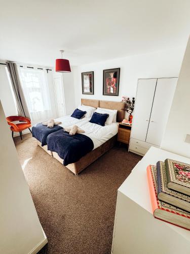 a bedroom with two beds with blue pillows at Bromley jefersons place in Bromley